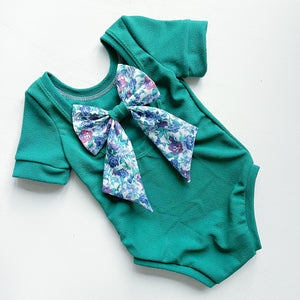 A pop of floral bow back bodysuit